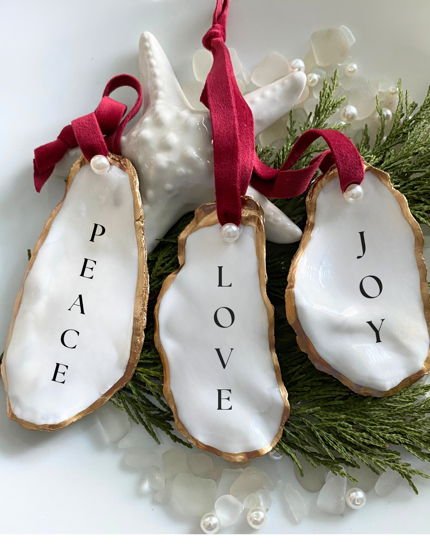 All natural handmade personalized oyster shell ornament with pearl paint and gold gild paint on edges adorned with ivory or rose gold satin ribbon and a cultured pearl