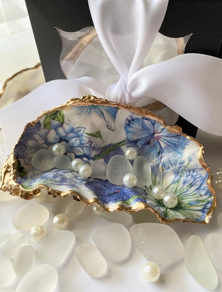 Blue and white floral design on an all natural cupped oyster shell featuring gold gild trim with a beautiful gift box ready to be gifted