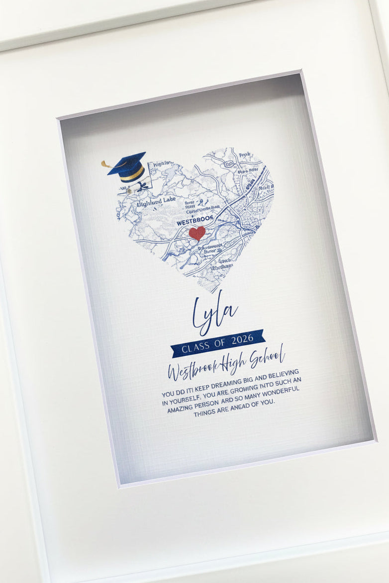 Framed personalized graduation-themed heart-shaped map print with text gift.