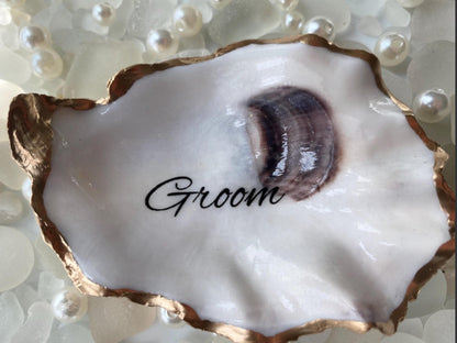 Oyster shell with 'Groom' text on a pearl background