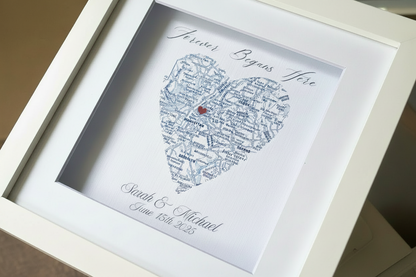 Framed heart-shaped artwork with personalized text and map, a wedding gift.
