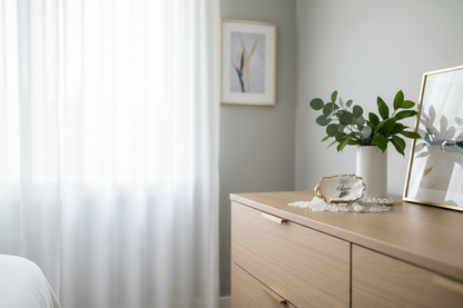 Oyster Shell Place Card Neatly arranged room with a dresser, plant, and framed pictures.