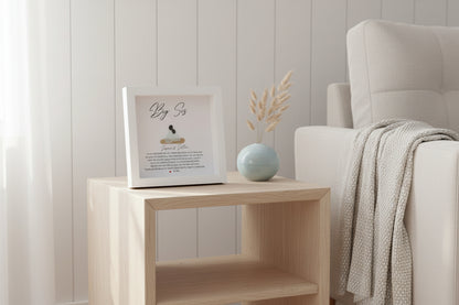 Personalized Big Sister gift with sea glass and pebble art, displayed in a white frame with a written message and a small sea glass figure.