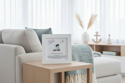 Living room with a framed picture on a coffee table, light-colored sofa, and decorative items.