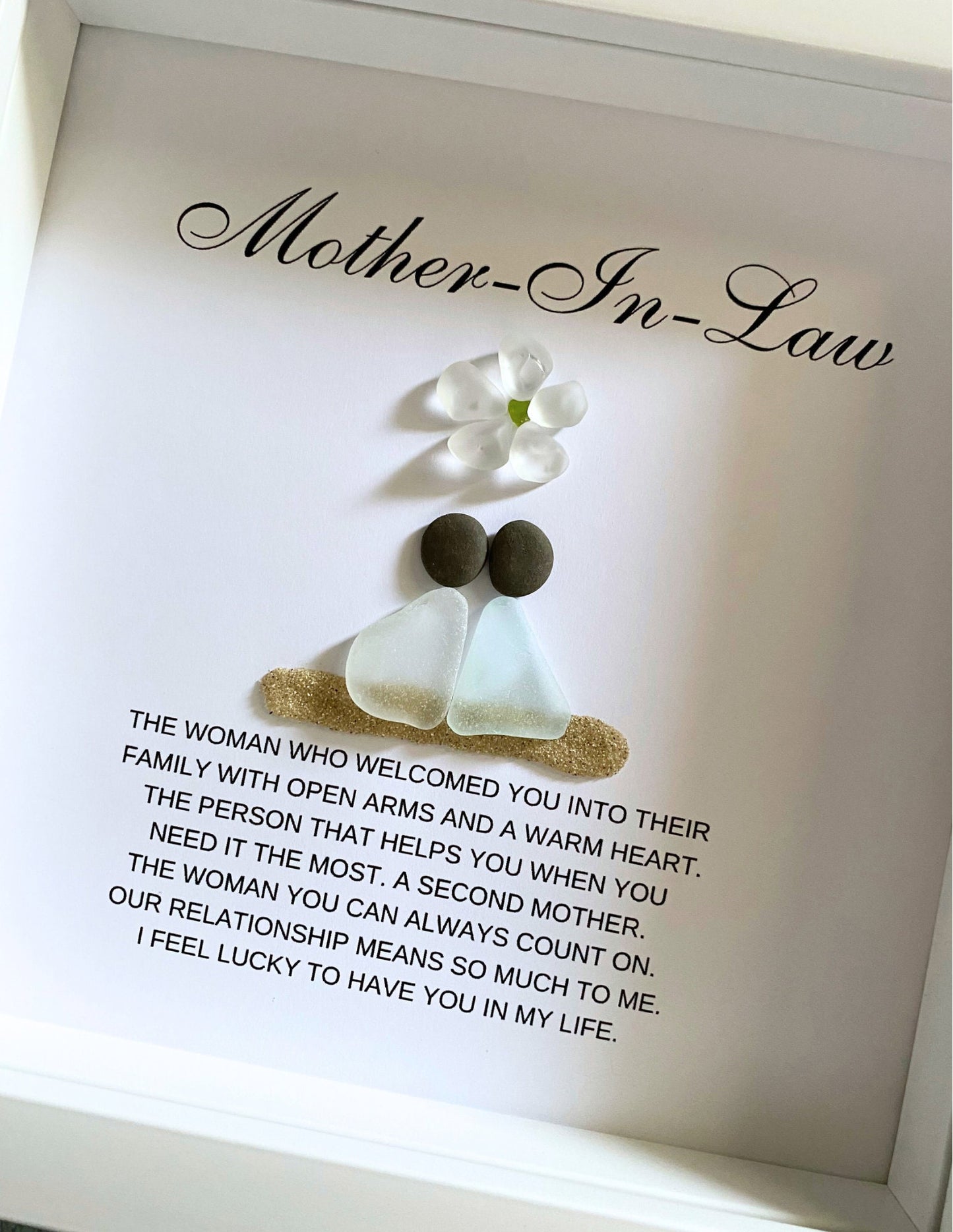 Personalized framed sea glass art for mother-in-law featuring two figures, a small glass flower, names, and custom message in a 9x9 shadow box.