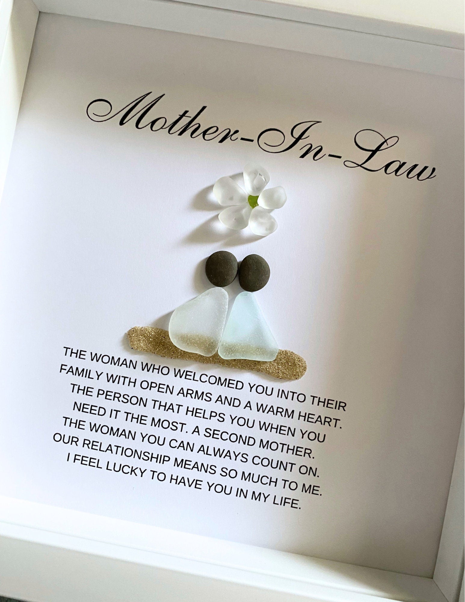 Personalized framed sea glass art for mother-in-law featuring two figures, a small glass flower, names, and custom message in a 9x9 shadow box.