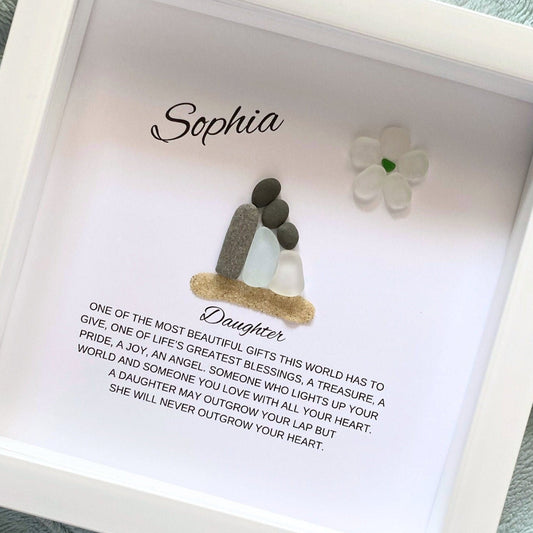 A personalized daughter gift featuring a framed shadowbox with sea glass and pebble art, with a personalized message and the name 'Sophia' inside the frame.