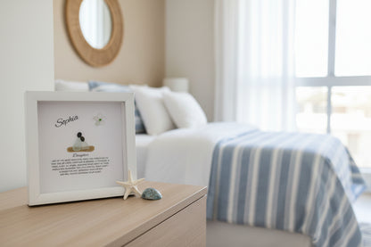 Decorative photo frame with text on a bedside table in a bedroom.
