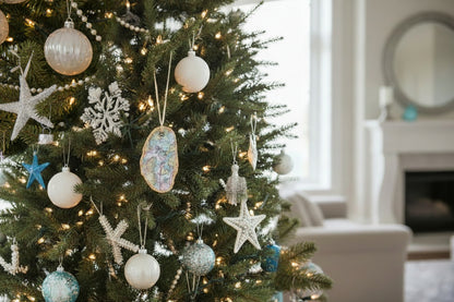 Decorated Christmas tree with assorted ornaments including Maine oyster ornament, stars, snowflakes, and spherical shapes.