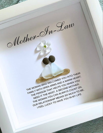 Personalized framed sea glass art for mother-in-law featuring two figures, a small glass flower, names, and custom message in a 9x9 shadow box.
