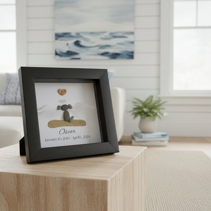A personalized dog memorial gift featuring a white sea glass and pebble art piece with a shadowbox frame.