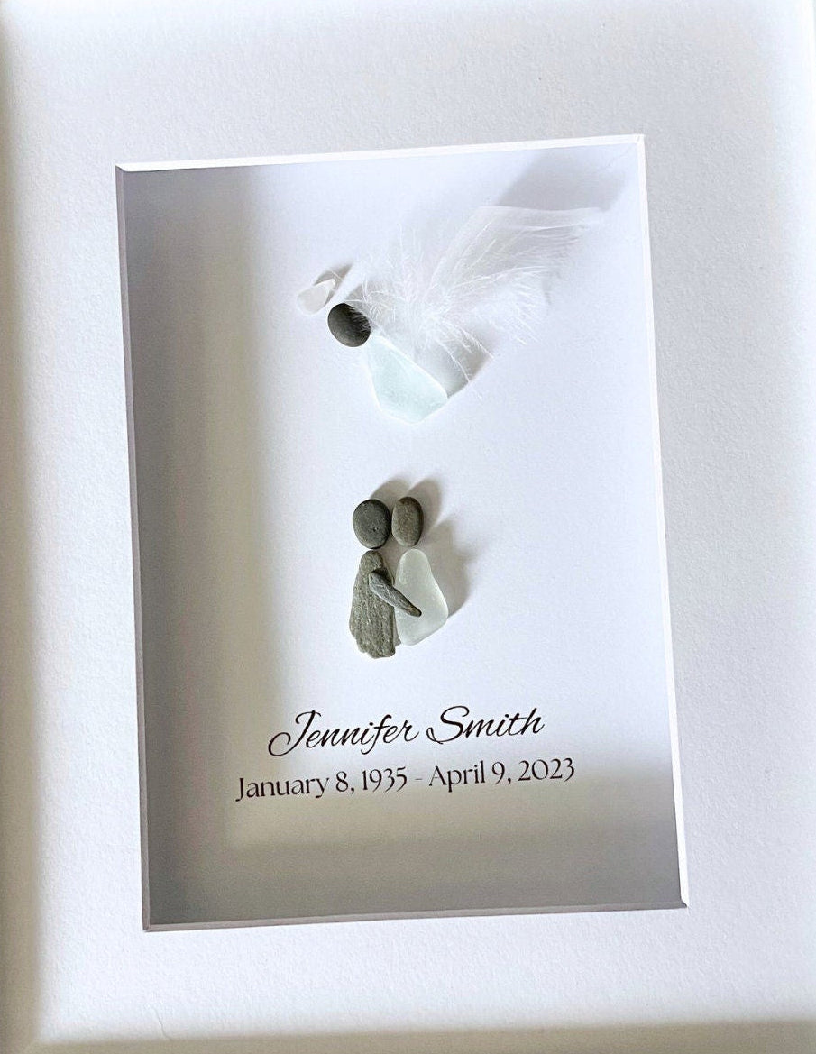 Memorial plaque with two small figures and engraved text on a white background