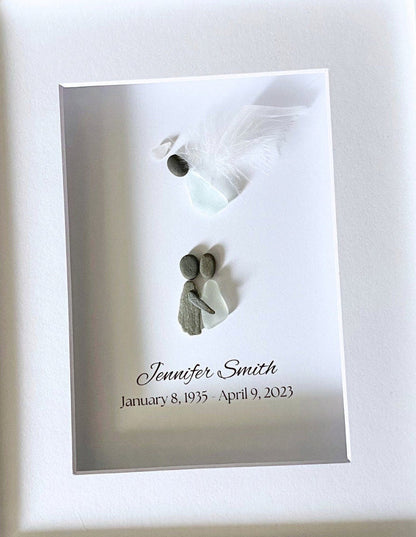 Memorial plaque with two small figures and engraved text on a white background