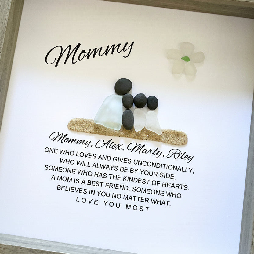 Mom and Daughter Sea glass figures with pebble heads sitting on sand with their names below and a little quote. On top it says "Mom" with a glass flower.