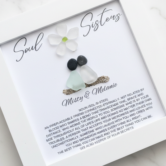A personalized framed art piece with sea glass and pebble, labeled 'Soul Sisters' for a friend or sister.