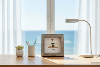 Desk setup with a framed photo, lamp, and small plants in a bright room.