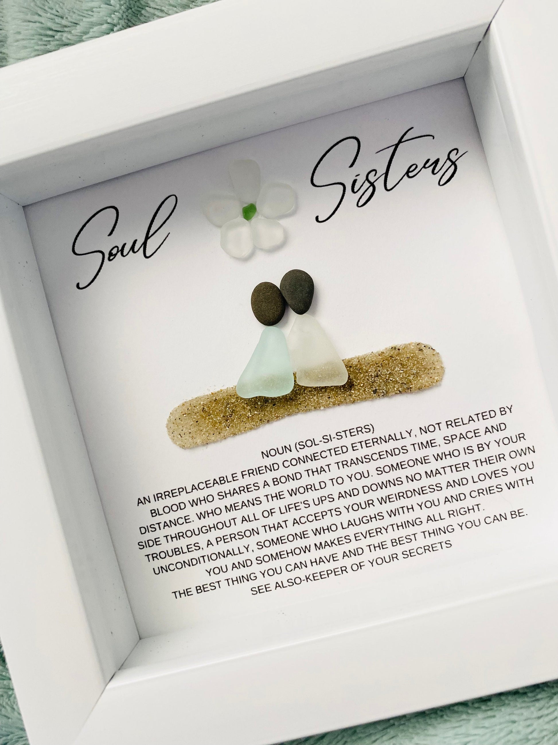 A personalized framed art piece with sea glass and pebble, labeled 'Soul Sisters' for a friend or sister.