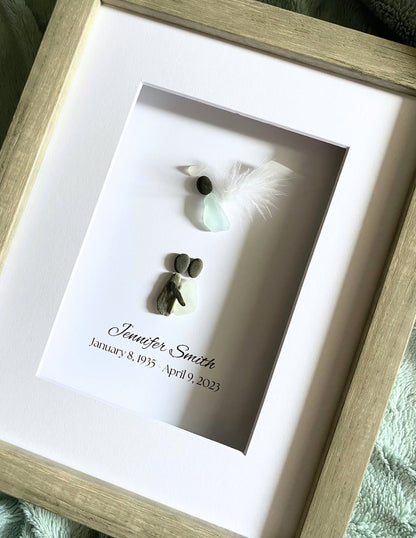 Framed memorial with a name and dates, featuring small decorative elements.